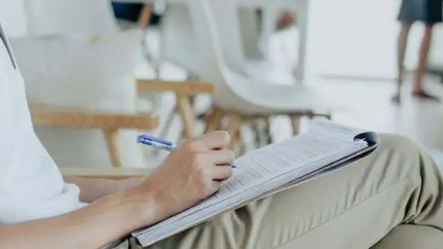 person writing on white sheet
